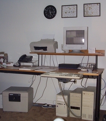 Emily's desk with fax machine and computer graveyard