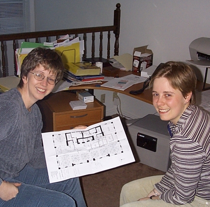 Kim and Emily checking the floor plan for the new office space