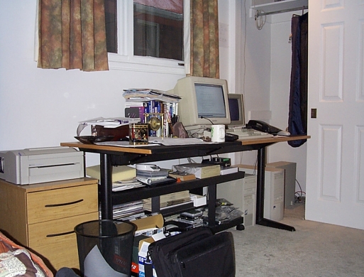 Joe's desk with server machines and laser printer
